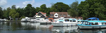 Womack Staithe on the Norfolk Broads with hire boats moored